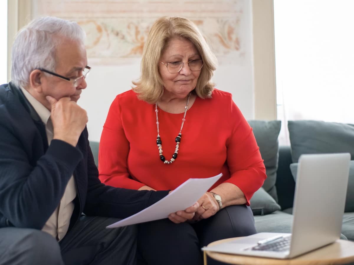 An older couple at home reading a health-plan document together